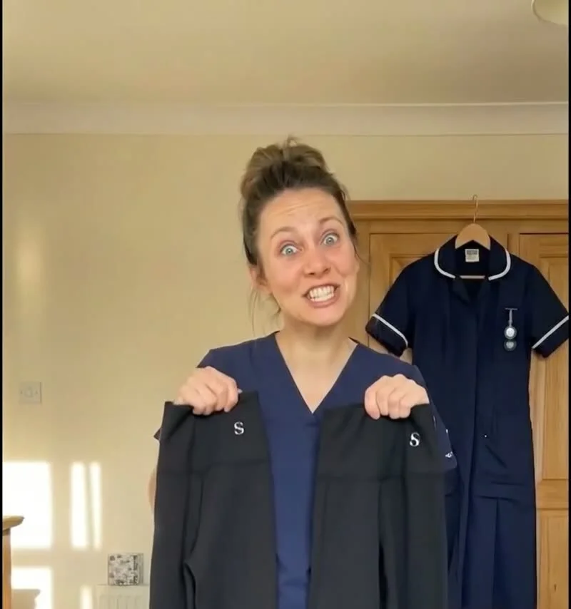 Nurse in scrubs holding up two pairs of Skinnify leggings